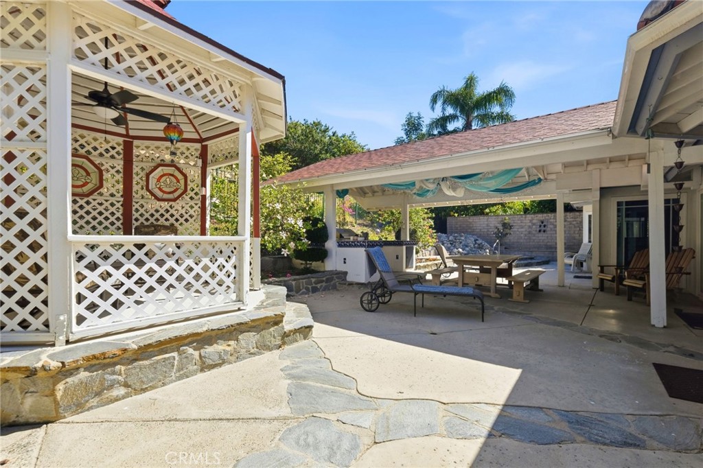 18233 Charlton Lane Porter Ranch, CA 91326 - Photo 22 of 40 a view of a patio with table and chairs