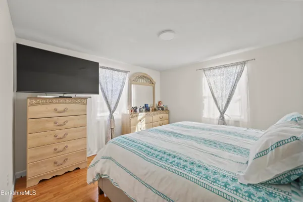 a bedroom with a bed and a flat screen tv