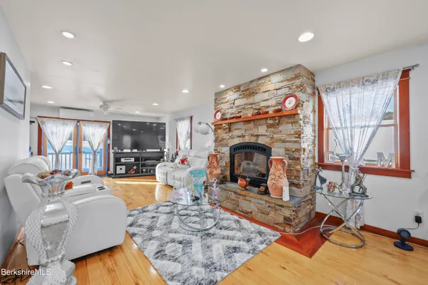 a living room with furniture a fireplace and a floor to ceiling window