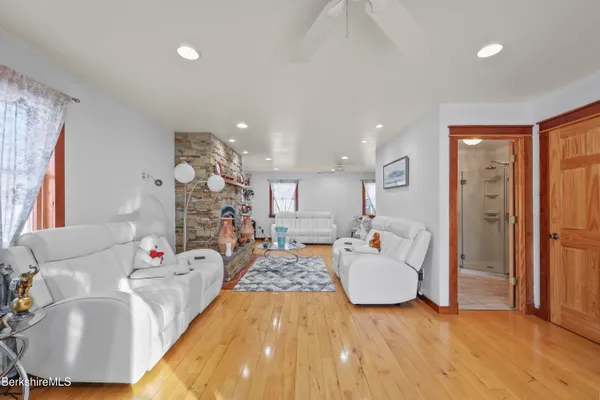 a living room with fireplace furniture and a wooden floor