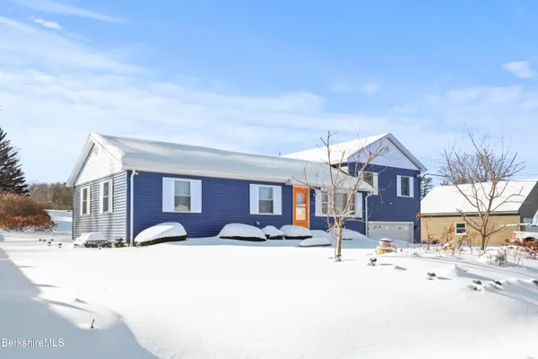 a view of a house with a snow on the road