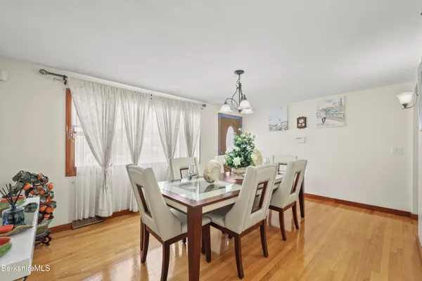 a view of a dining room with furniture and wooden floor