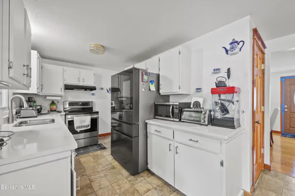 a kitchen with a sink stove and refrigerator