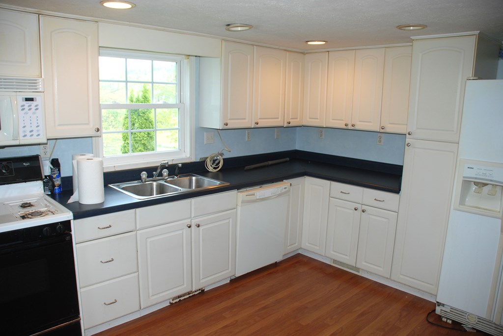 4659 South Mechanicsville Road Clarion, PA 16214 - Photo 12 of 35 a kitchen with granite countertop white cabinets and white appliances