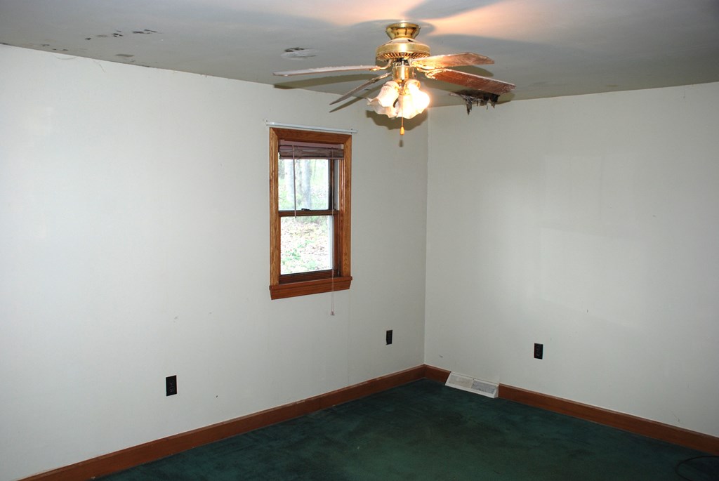 4659 South Mechanicsville Road Clarion, PA 16214 - Photo 20 of 35 an empty room with a chandelier fan and wooden floor