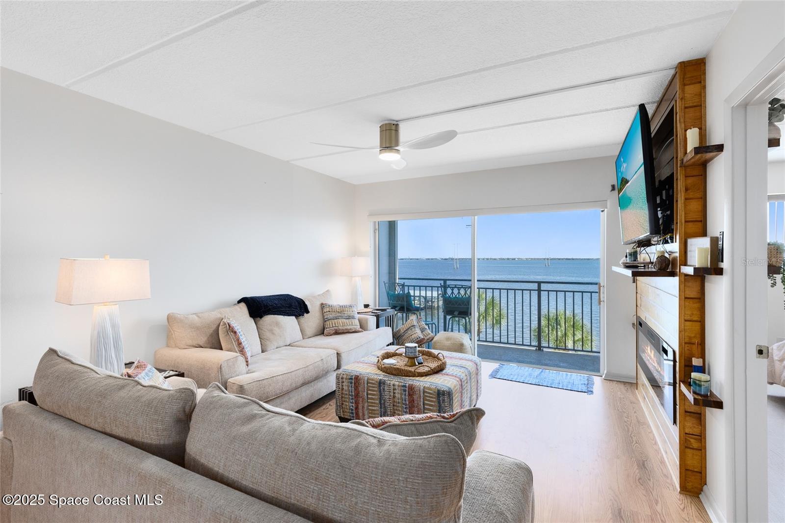 3901 Dixie Highway Northeast, Unit 409 Palm Bay, FL 32905 - Photo 11 of 40 a living room with furniture and a table