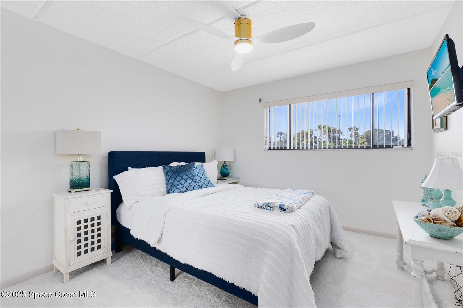 3901 Dixie Highway Northeast, Unit 409 Palm Bay, FL 32905 - Photo 20 of 40 a bedroom with a bed and a dresser with window