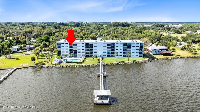 a small pool with outdoor seating and yard in the back