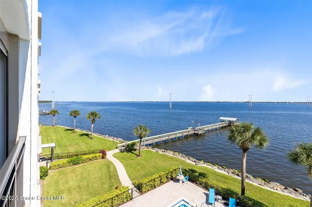 a view of a pool with a lounge chair