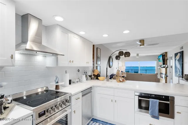 a kitchen with kitchen island a sink stove and cabinets