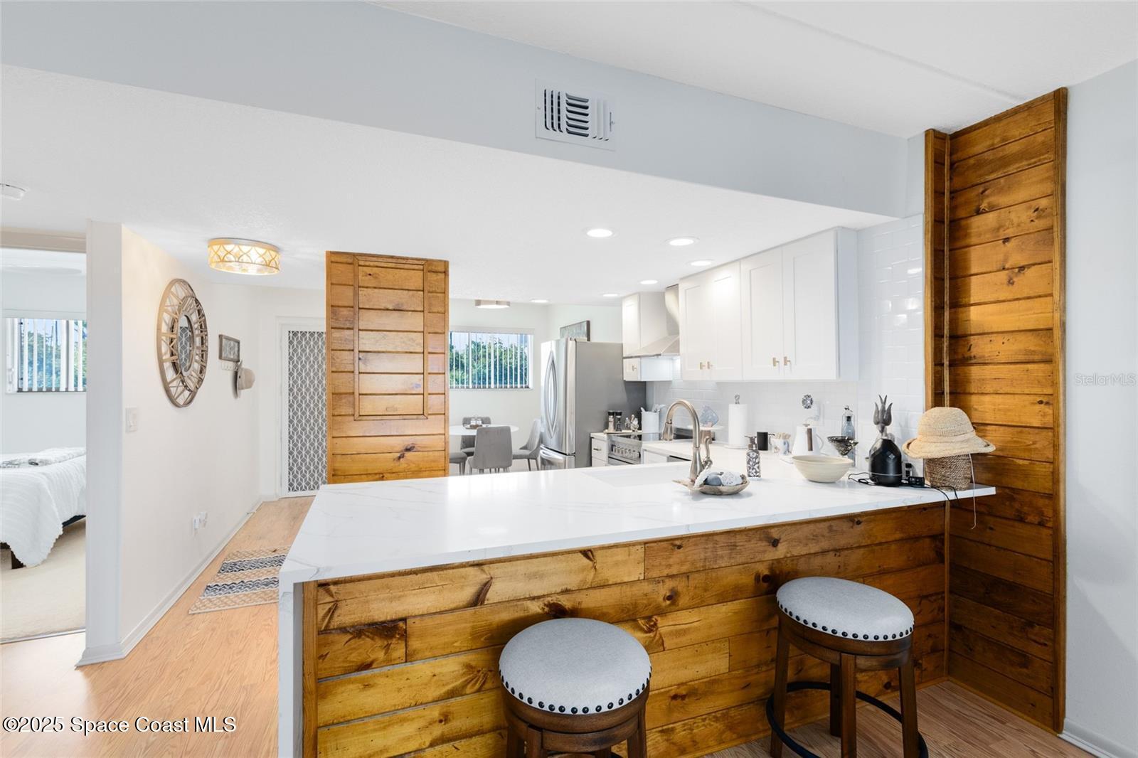 3901 Dixie Highway Northeast, Unit 409 Palm Bay, FL 32905 - Photo 7 of 40 a bathroom with a granite countertop sink a toilet and a mirror