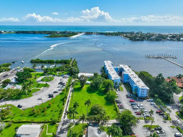 an aerial view of a house with a yard and lake view