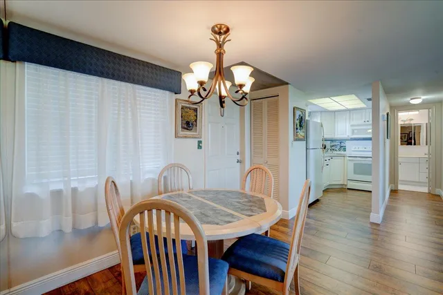 a view of a a dining room with furniture window and wooden floor