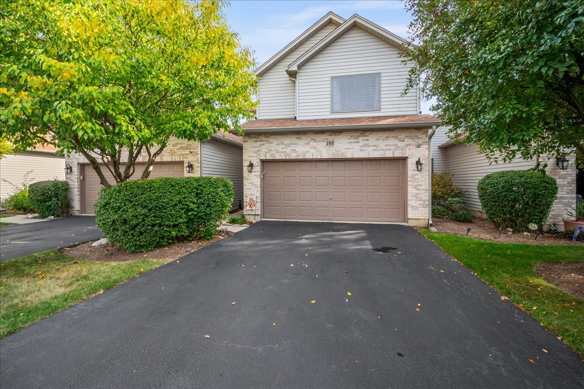 a view of a house with a yard and garage