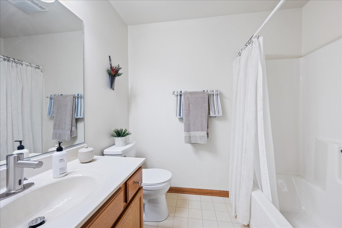 103 Fawn Lane Elgin, IL 60120 - Photo 19 of 31 a bathroom with a sink a toilet and shower curtain