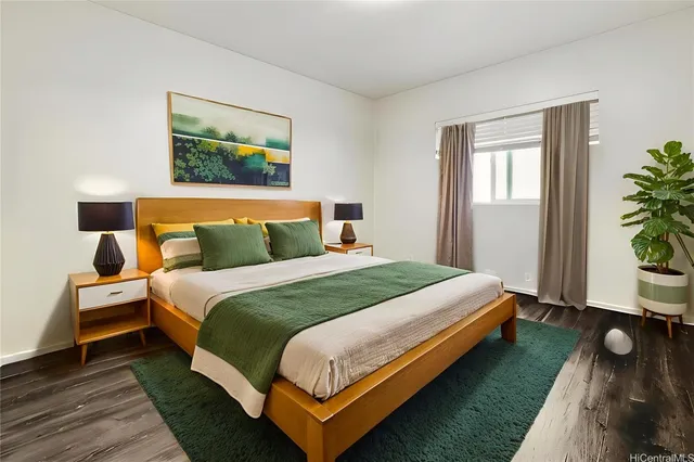 a bedroom with a bed and a painting on the wall