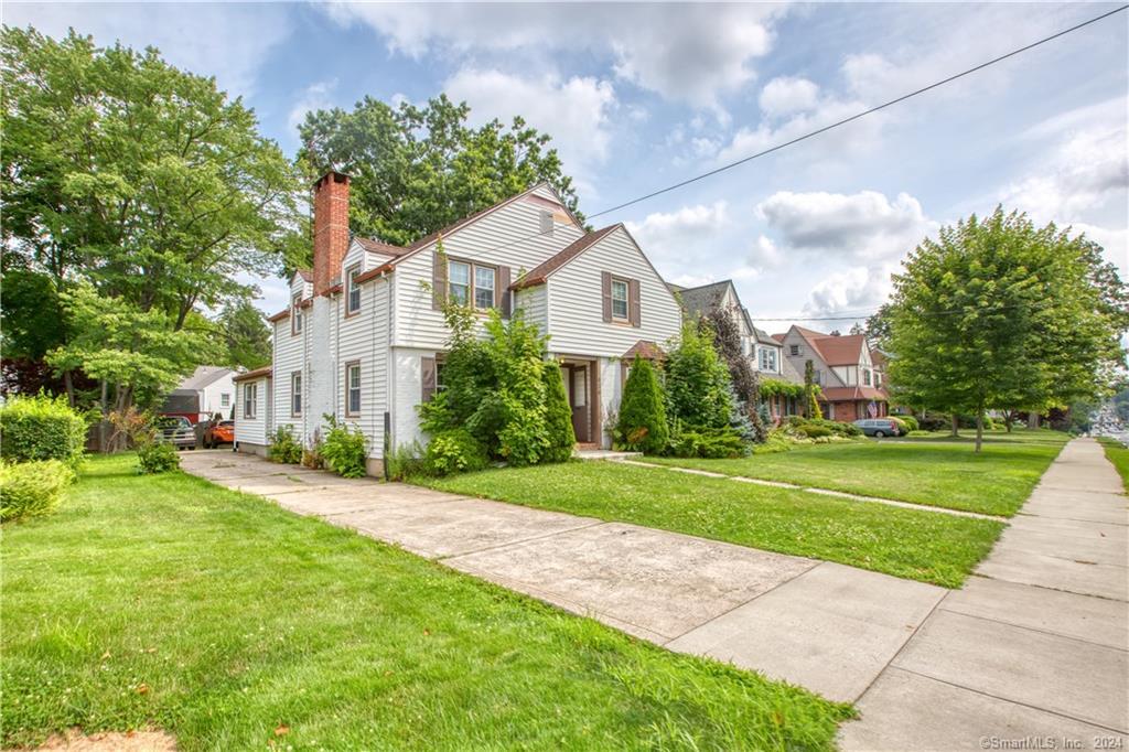 626 Park Road West Hartford, CT 06107 - Photo 1 of 1 a front view of a house with a yard and trees