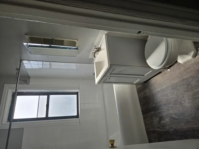 a bathroom with a mirror and a toilet