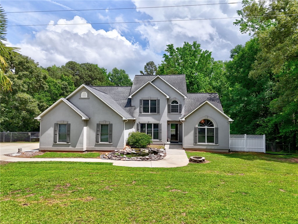 1016 Campbell Road Belton, SC 29627 - Photo 1 of 50 A graceful home with a welcoming front path, nestled amidst lush greenery and mature trees.