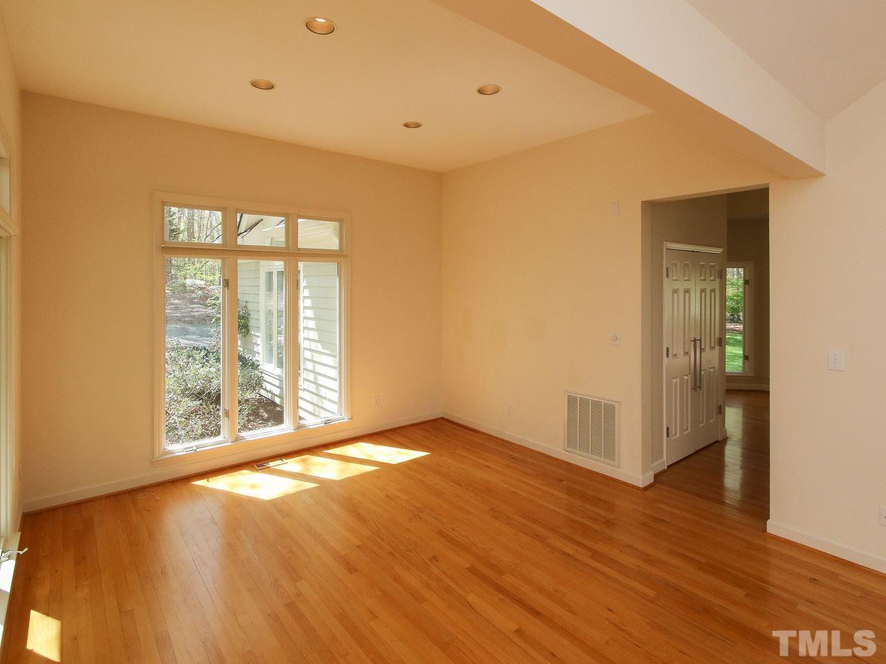 616 Booth Road Chapel Hill, NC 27516 - Photo 11 of 26 an empty room with wooden floor and windows