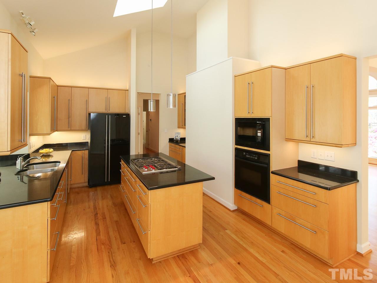 616 Booth Road Chapel Hill, NC 27516 - Photo 12 of 26 a kitchen with stainless steel appliances granite countertop a refrigerator a stove and a wooden floors
