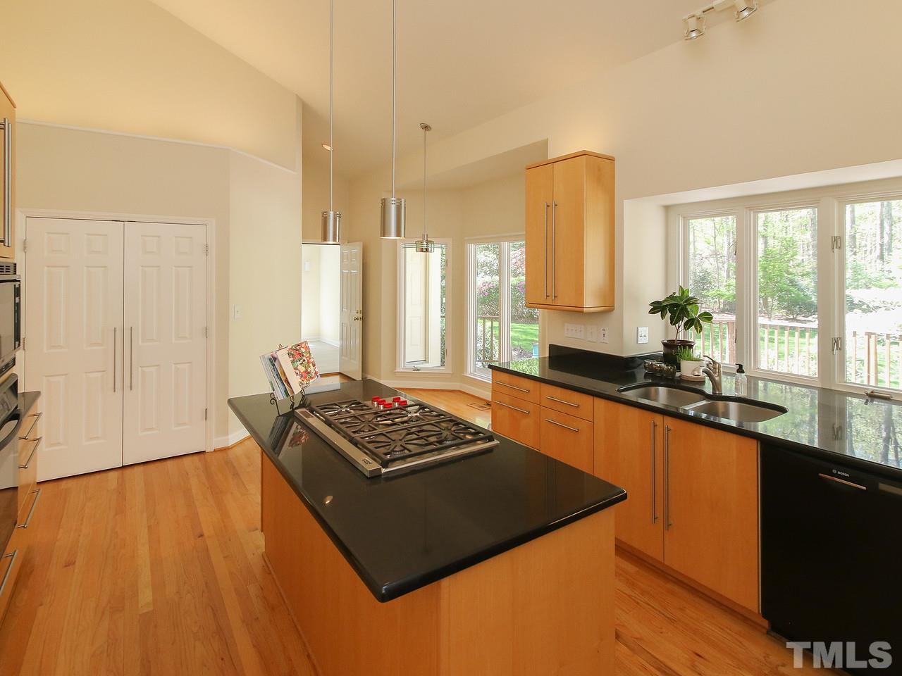 616 Booth Road Chapel Hill, NC 27516 - Photo 13 of 26 a kitchen with stainless steel appliances granite countertop a stove a sink and a microwave