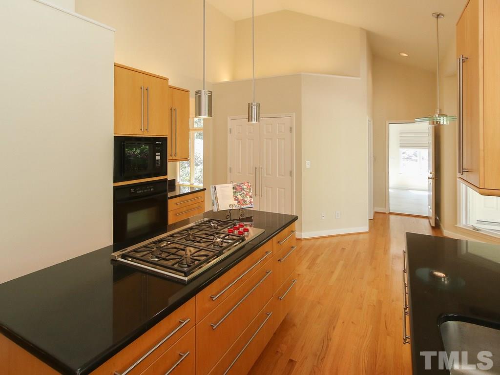 616 Booth Road Chapel Hill, NC 27516 - Photo 14 of 26 a kitchen with wooden floor and a stove top oven