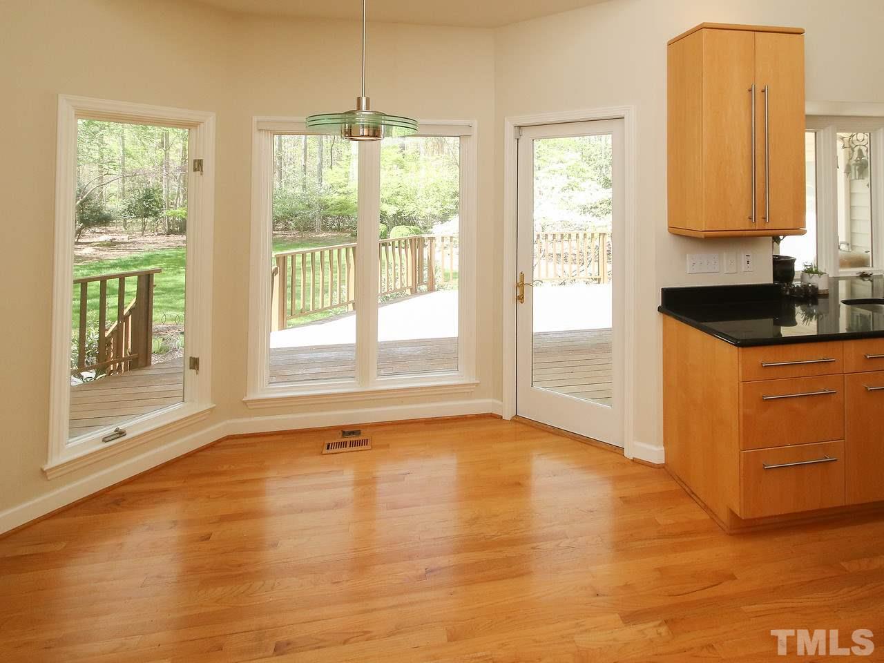 616 Booth Road Chapel Hill, NC 27516 - Photo 15 of 26 a view of an empty room with a window and wooden floor