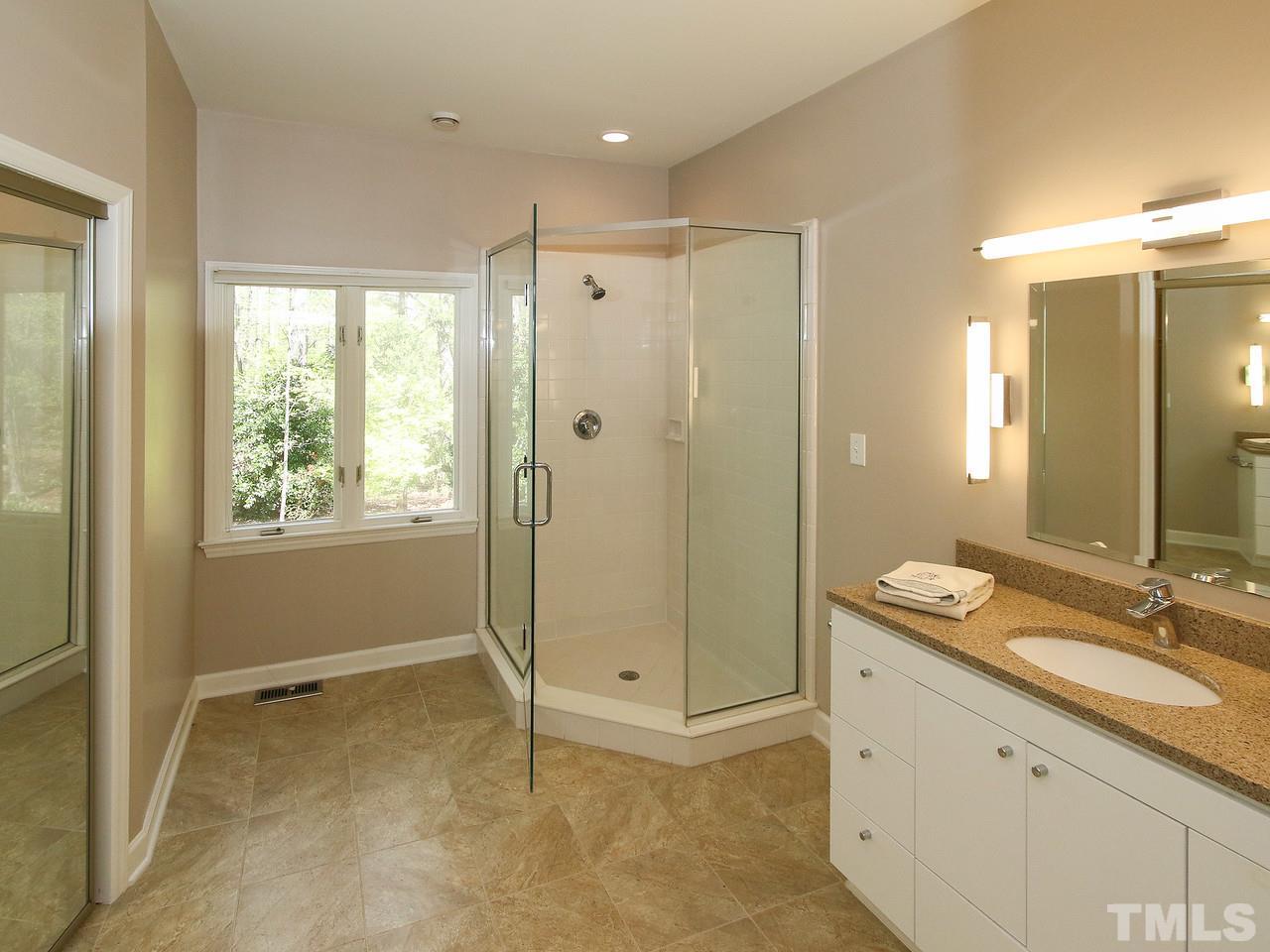 616 Booth Road Chapel Hill, NC 27516 - Photo 17 of 26 a bathroom with a granite countertop sink mirror shower and double