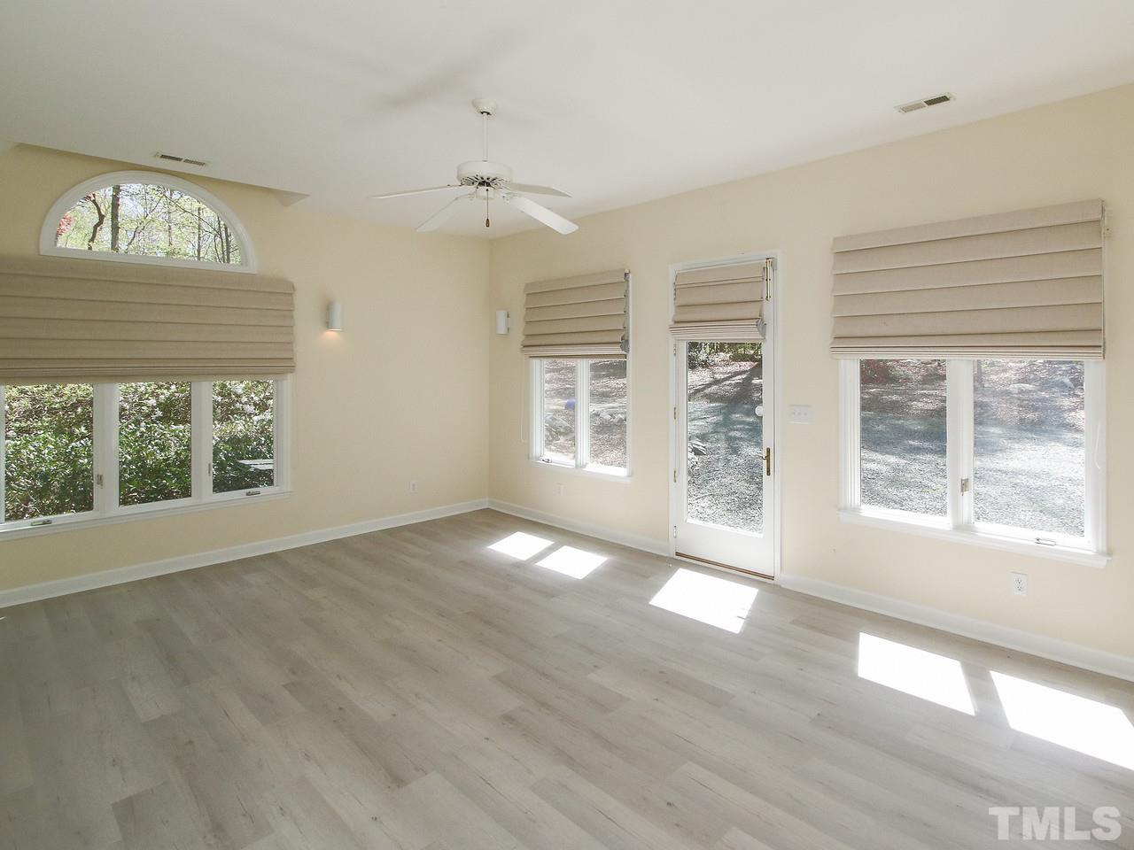 616 Booth Road Chapel Hill, NC 27516 - Photo 21 of 26 a view of an empty room with a window and wooden floor