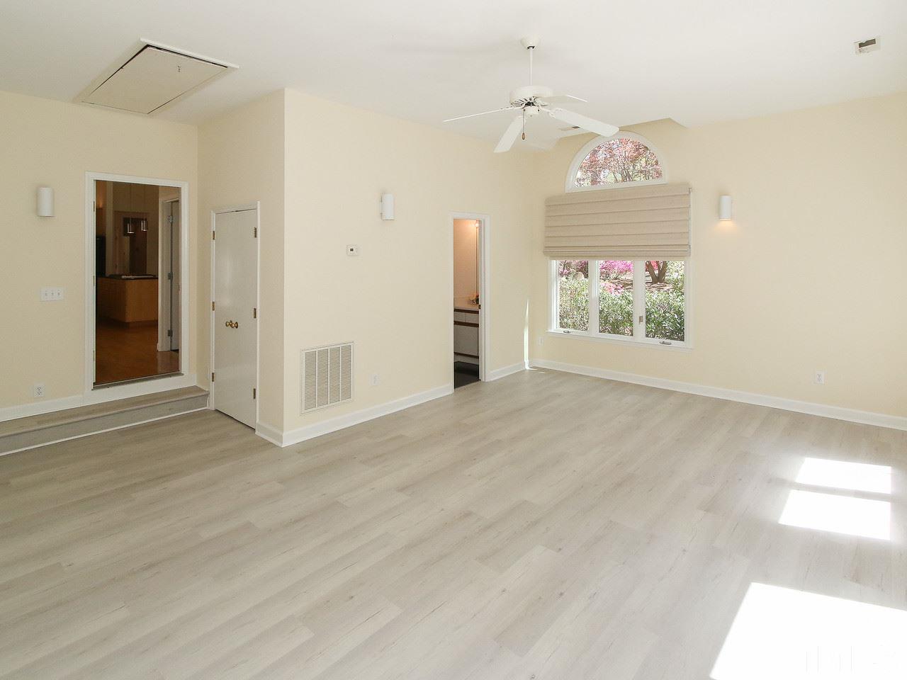 616 Booth Road Chapel Hill, NC 27516 - Photo 22 of 26 an empty room with wooden floor and windows