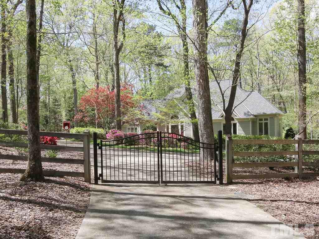 616 Booth Road Chapel Hill, NC 27516 - Photo 26 of 26 a view of a house with a small yard and wooden fence