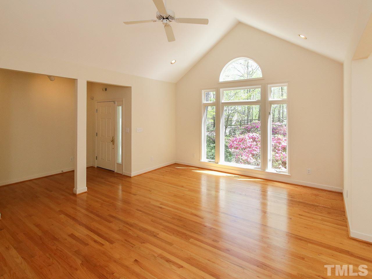 616 Booth Road Chapel Hill, NC 27516 - Photo 8 of 26 an empty room with wooden floor fan and windows