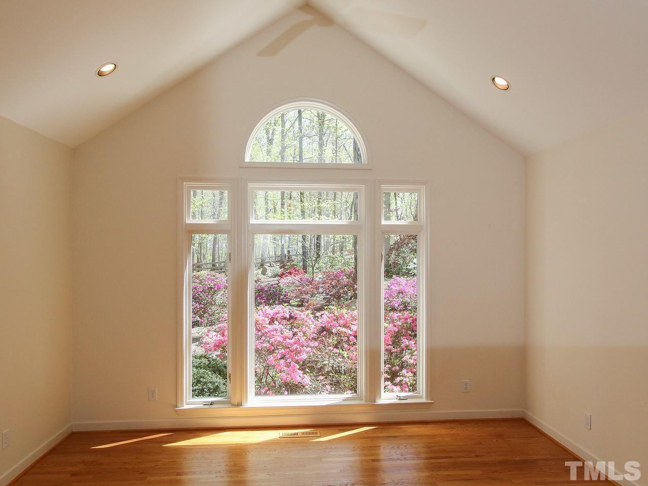 616 Booth Road Chapel Hill, NC 27516 - Photo 9 of 26 an empty room with wooden floor and windows