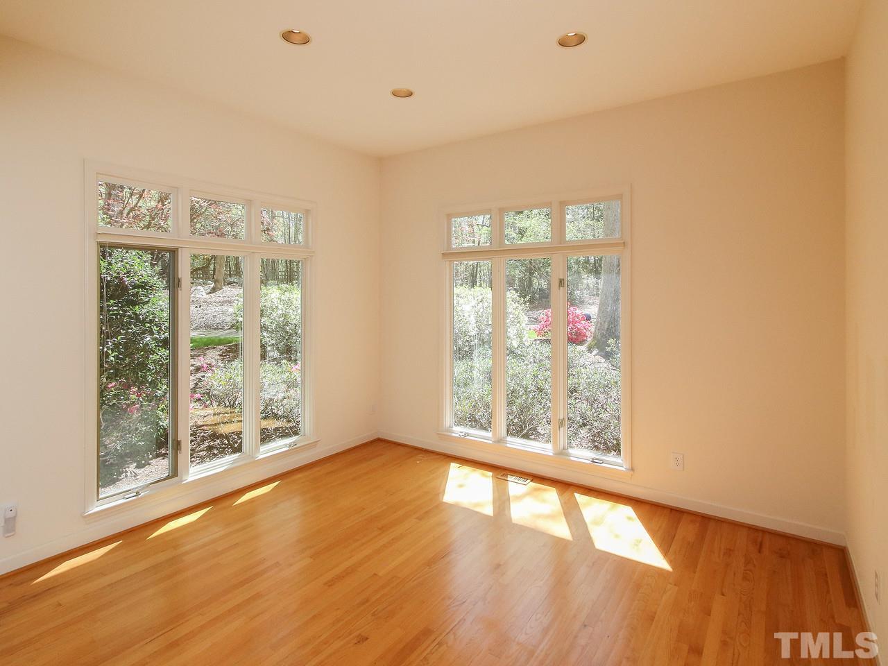 616 Booth Road Chapel Hill, NC 27516 - Photo 10 of 26 a view of an empty room with wooden floor and a window