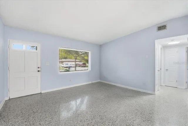 a view of an empty room with a window