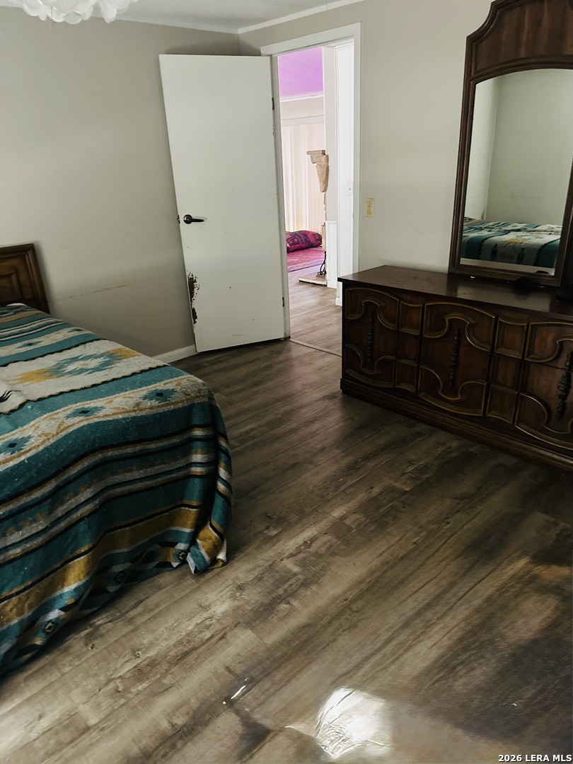 8790 Whartons Dock Road Bandera, TX 78003 - Photo 7 of 12 a bedroom with a bed and a flat screen tv