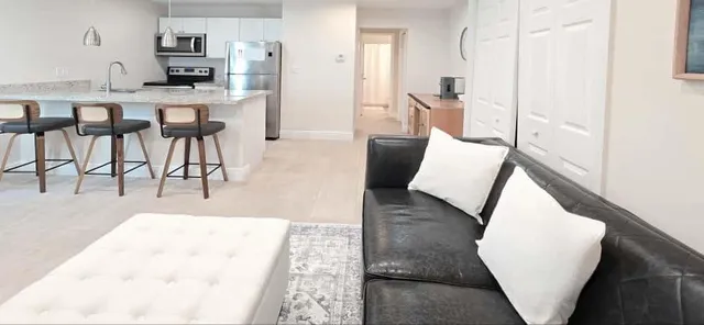 a kitchen with stainless steel appliances kitchen island granite countertop a refrigerator and a stove top oven