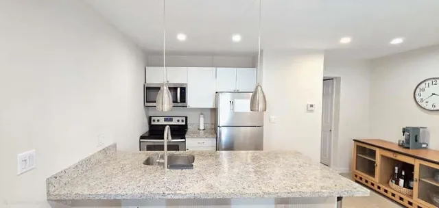 a bedroom with a bed and a night stand