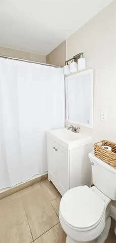 a kitchen with stainless steel appliances granite countertop a stove a refrigerator a kitchen island a dining table and chairs with wooden floor