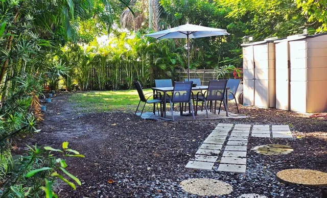 a living room with furniture a flat screen tv and kitchen view