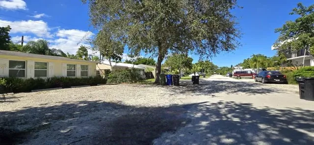 a living room with furniture and a dining table with kitchen view
