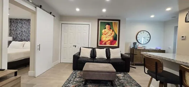 a kitchen with stainless steel appliances granite countertop a stove a refrigerator and a dining table with wooden floor