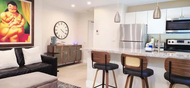 a large bed sitting in a bedroom next to a window