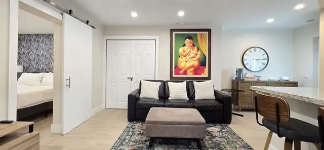 a bed sitting in a bedroom next to a window