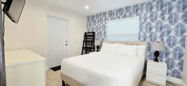 a view of a pathway of a house with wooden fence
