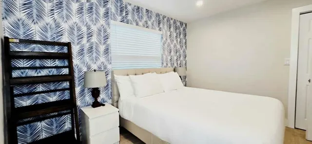 a white toilet sitting next to a bathroom sink