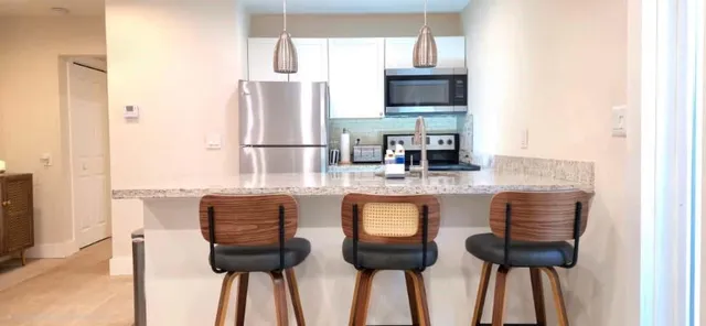 a bathroom with a sink a toilet a mirror a vanity and shower