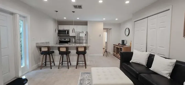 a kitchen with stainless steel appliances granite countertop a stove a sink and a refrigerator