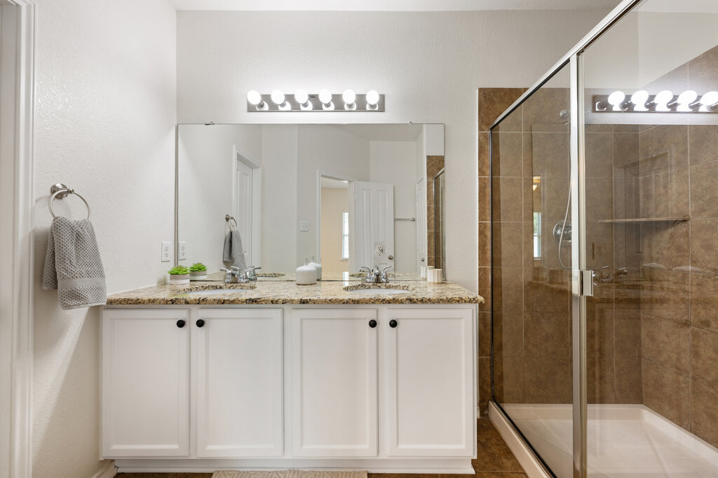 11744 Easy Street Austin, TX 78748 - Photo 30 of 40 A spacious double vanity pairs with a glass-enclosed walk-in tile shower.